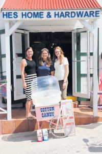 From left: Child Focus project leader Stacey Simmons receiving a cotton-candy machine from HES Home and Hardware (Do-it-Best) manager Ruthanne Rakutt and employee Sheree Dooley.