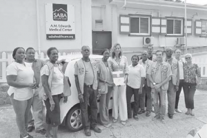 From left: Lisette Riley, Kirt Whittle, Shirley Woods, George Wilson, Saba Lions Club President Jessica Gumbs, Saba Health Care Director Joka Blaauboer, Arabella Hassell, Hubert “Roy” Smith, Vincent troom, Carl Buncamper, Franklin Wilson, Rudolph Hassell and Wilma Hassell in front of the Meals on Wheels vehicle.