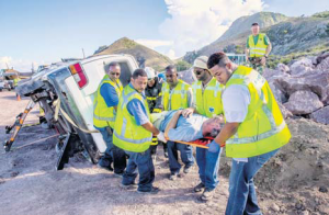 Saba health-care workers carrying a victim to safety.