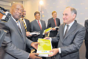 St. Eustatius Commissioner Reginald Zaandam (left) receives the four reports of the 2015 Caribbean Netherlands evaluation from Member of the Evaluation Committee Fred Soons during the official presentation in The Hague on Monday. (Suzanne Koelega photo)