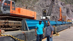 Harbormaster Travis Johnson(r) and Manager, Devcon International, Conley Browne, in front of the 2000 ton barge that will be used to dredge the Capt. L. A. I. Chance Pier.