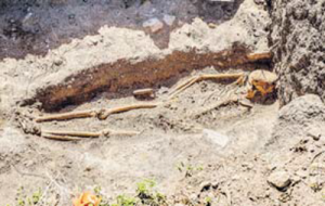 The skeletal remains of the pregnant woman with the bones of her unborn child still visible.