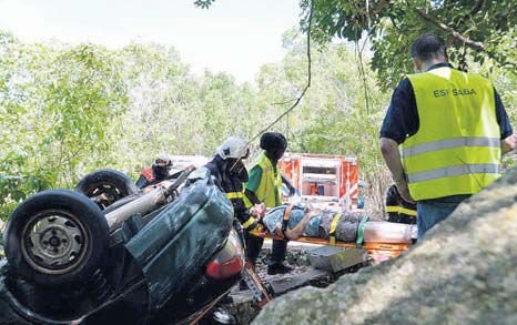 Medical personnel and fire fighters assisting a “victim” of a traffic accident on Well’s Bay Road during an exercise on Friday.