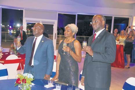 From left: Prime Minister William Marlin, Marie-Louise Holiday and Governor Eugene Holiday toast to the continued success of local airline Winair during its 55th anniversary cocktail reception on Friday. (Andrew Dick photo)